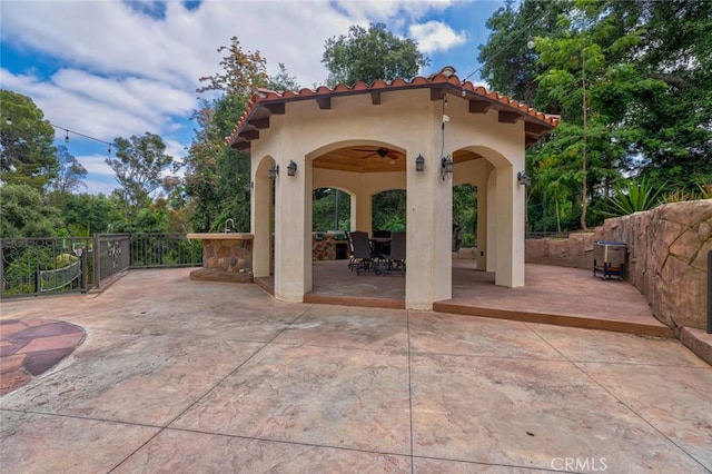 view of patio featuring ceiling fan