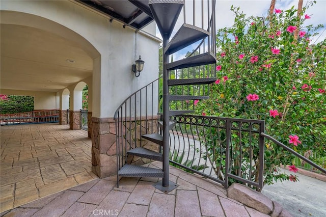 entrance to property featuring stucco siding