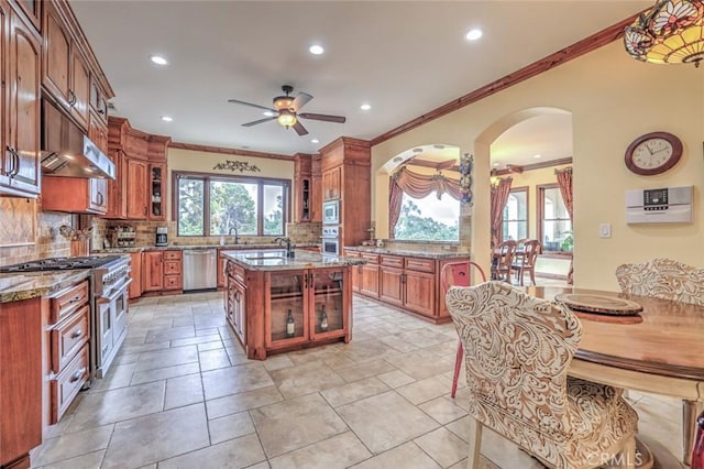 kitchen with a ceiling fan, ornamental molding, under cabinet range hood, and stainless steel appliances