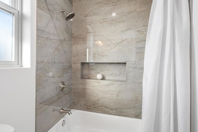 bathroom with shower / bath combination with curtain