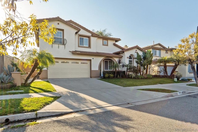 mediterranean / spanish-style home featuring a front yard and a garage