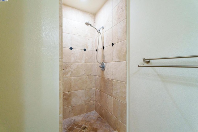 bathroom with a tile shower