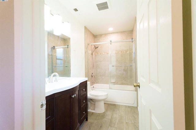 full bathroom featuring vanity, toilet, and tiled shower / bath combo