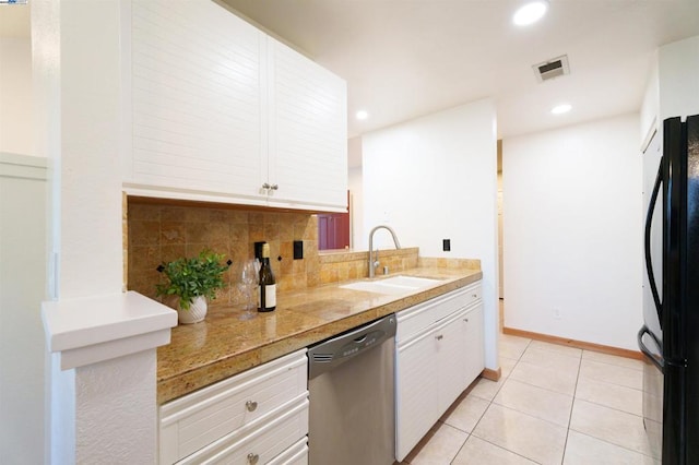 kitchen featuring black fridge, dishwasher, sink, and white cabinets