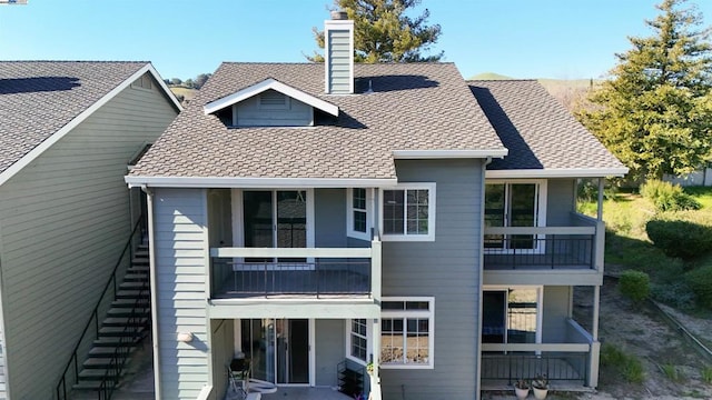 back of property featuring a balcony