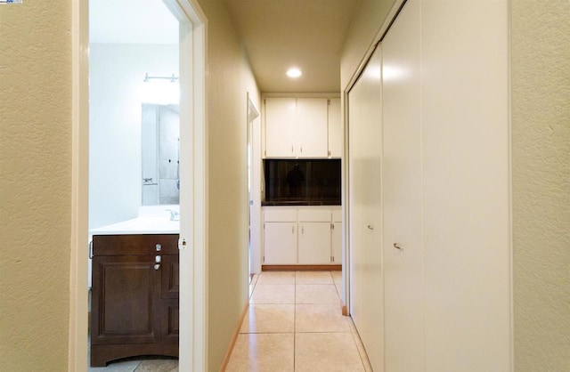 hallway featuring light tile patterned floors