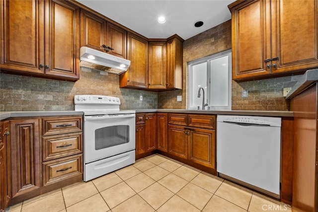 kitchen featuring light tile patterned flooring, sink, backsplash, and white appliances