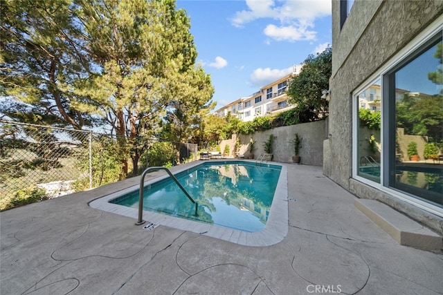 view of swimming pool with a patio area