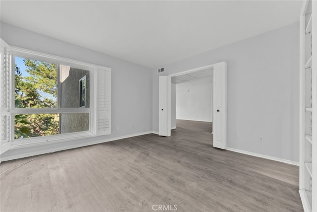 empty room with wood-type flooring