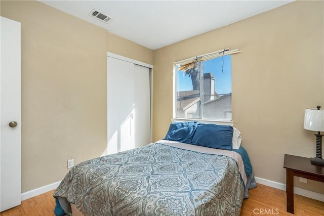 bedroom featuring hardwood / wood-style flooring and a closet