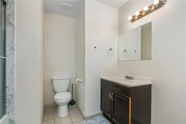 bathroom with vanity, toilet, and tile patterned flooring