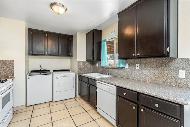 kitchen featuring sink, tasteful backsplash, separate washer and dryer, dark brown cabinets, and white appliances