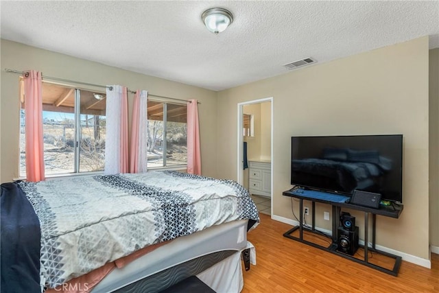 bedroom featuring hardwood / wood-style floors and a textured ceiling