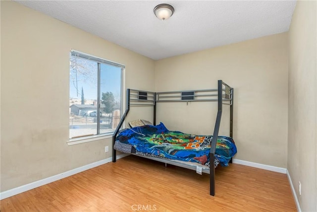 bedroom with hardwood / wood-style flooring