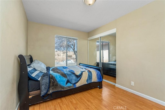 bedroom featuring wood-type flooring and a closet