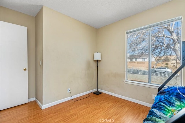 unfurnished bedroom with wood-type flooring and a textured ceiling