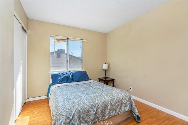 bedroom with hardwood / wood-style floors and a closet