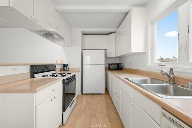 kitchen with white cabinetry, sink, white appliances, and light hardwood / wood-style flooring