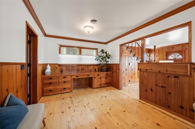 bathroom featuring wood walls, crown molding, and wood-type flooring