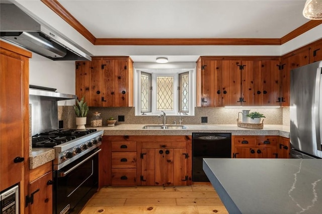 kitchen featuring light hardwood / wood-style flooring, appliances with stainless steel finishes, sink, backsplash, and extractor fan