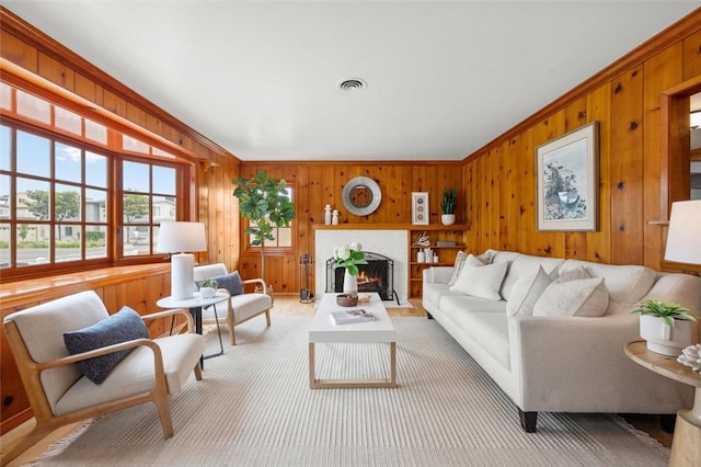 living room with wooden walls and a fireplace