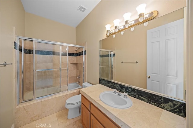 full bathroom with toilet, vanity, shower / bath combination with glass door, and tile patterned flooring