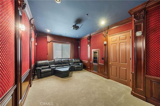 home theater room featuring ornamental molding and carpet flooring