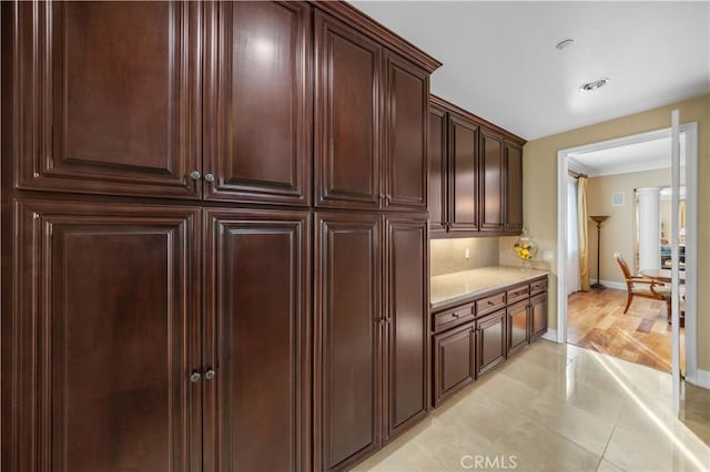 kitchen with light tile patterned floors and tasteful backsplash