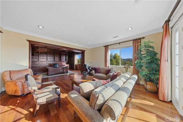 living room with light hardwood / wood-style floors and ornamental molding