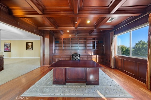 office area with light hardwood / wood-style floors, ornamental molding, wooden ceiling, beam ceiling, and coffered ceiling