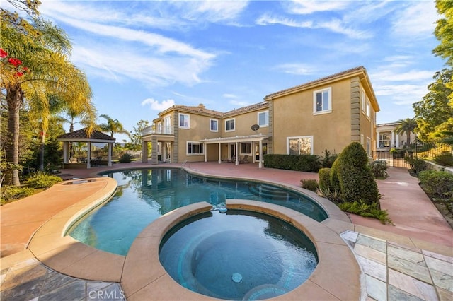 view of swimming pool featuring a gazebo, a patio, and an in ground hot tub