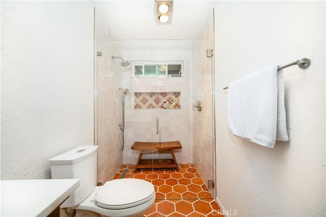 bathroom with toilet and walk in shower