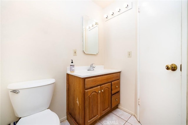 bathroom featuring toilet, vanity, and tile patterned flooring