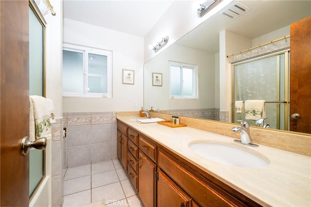 bathroom with tile patterned flooring, tile walls, and vanity