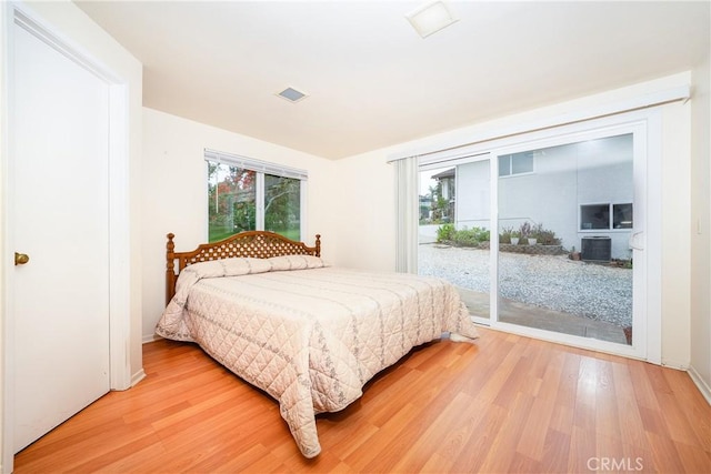 bedroom featuring hardwood / wood-style flooring and access to outside