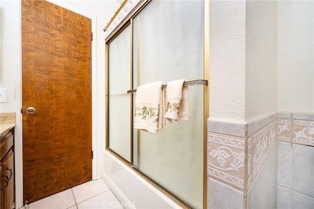 bathroom featuring vanity, tile patterned flooring, and shower / bath combination with glass door