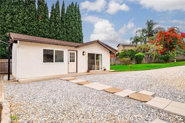 rear view of property featuring a yard