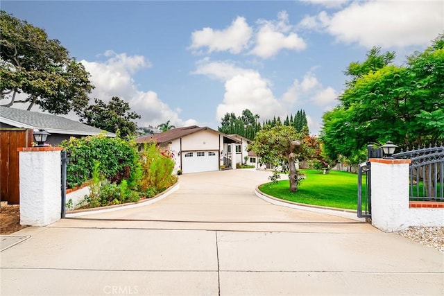 view of front of home featuring a garage and a front lawn