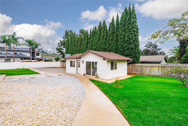 view of front facade with a front lawn and an outbuilding