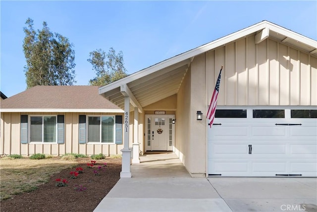 view of front of property featuring board and batten siding, concrete driveway, and a garage