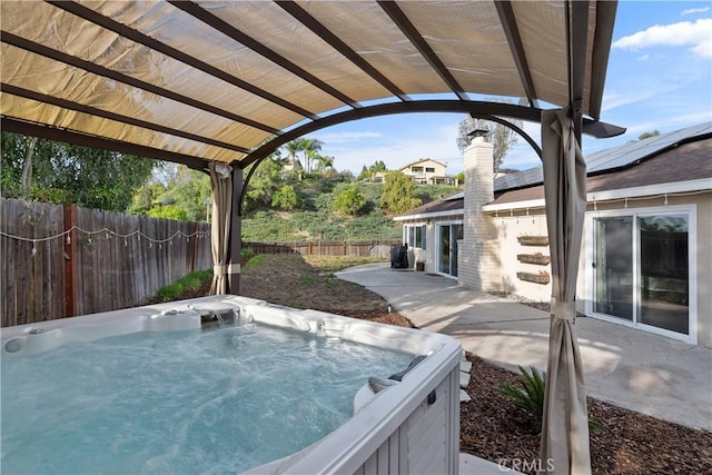 view of swimming pool featuring a hot tub and a patio