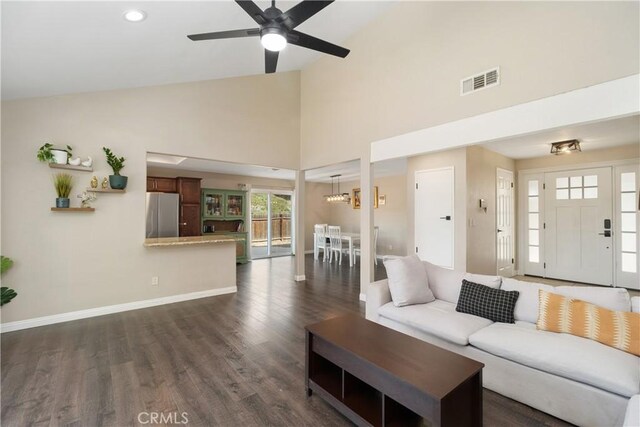 living room with ceiling fan, dark hardwood / wood-style flooring, and high vaulted ceiling