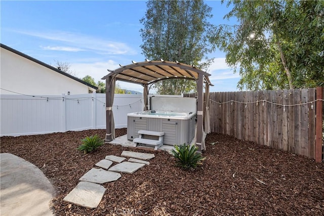 view of yard with a hot tub and a pergola