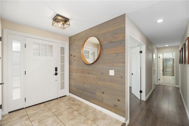 entryway featuring wood walls