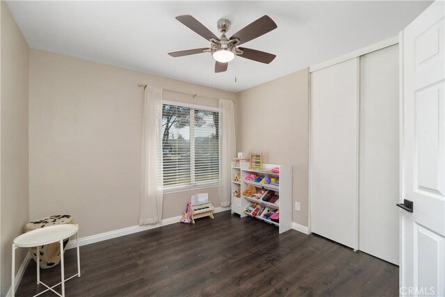 recreation room featuring ceiling fan and dark hardwood / wood-style flooring