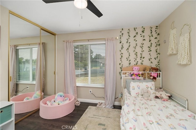 bedroom featuring dark hardwood / wood-style floors, a closet, and ceiling fan