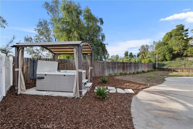 view of yard with a gazebo, a hot tub, and a patio