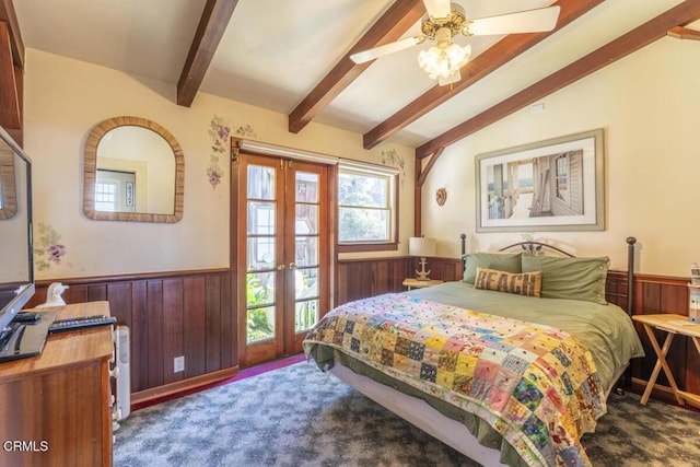 carpeted bedroom featuring wooden walls, french doors, vaulted ceiling with beams, and a wainscoted wall