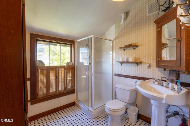 bathroom with visible vents, toilet, a stall shower, wallpapered walls, and baseboards