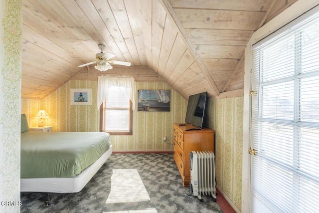 carpeted bedroom with wallpapered walls, radiator heating unit, multiple windows, and lofted ceiling